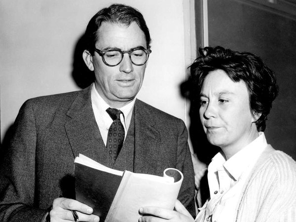 Harper Lee, right, looks over her book To Kill a Mockingbird, with the star of the film, actor Gregory Peck, in 1962.