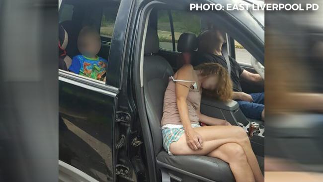 The photo that shocked the nation: Parents, passed out after using heroin, slump in their car as their child waits patiently in the car seat.