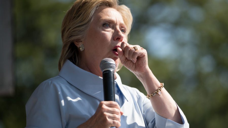 Democratic presidential candidate Hillary Clinton stops her speech to cough at the 11th Congressional District Labor Day festival at Luke Easter Park in Cleveland, Ohio, Monday, Sept. 5, 2016. (AP Photo/Andrew Harnik)