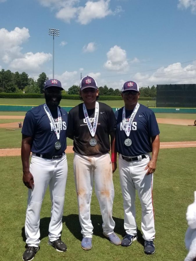 Azael Hernandez (center) celebrates his silver medal victory at the NTIS tournament this past week in North Carolina.