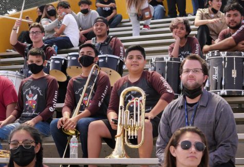 Mr. Kenneth Taber (left), takes a break with his band students between performances at last Fridays football game vs. Alta Loma.
