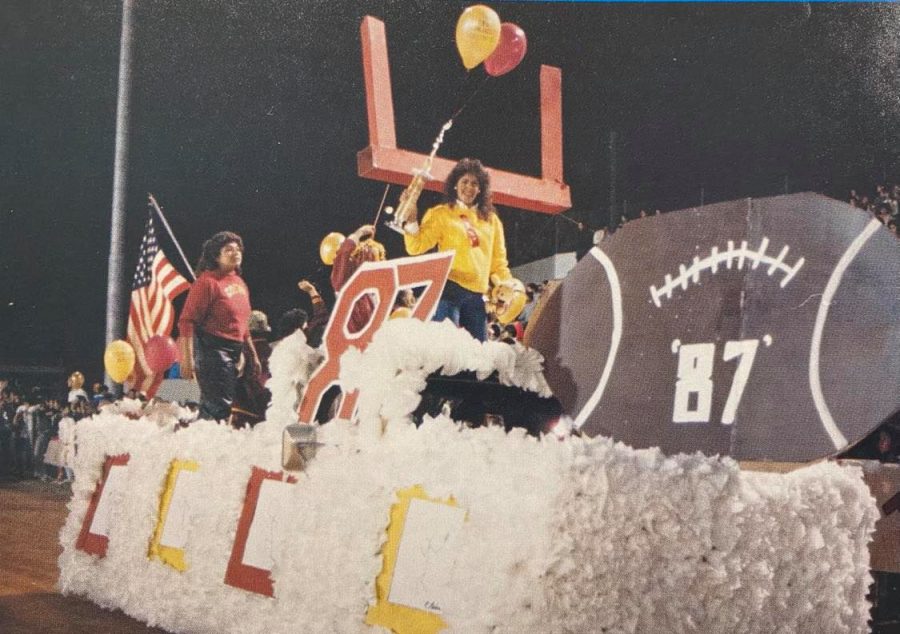 Sophomore Claudia Reyes hoists the trophy for Best Float, awarded to the Class of 1987 at the 1984 Homecoming Parade.