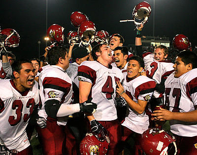 Colton center Devan Hussey celebrates with his teammates after Colton beat Rancho Verde 17-7 to win the CIF Central Division championship game at Rancho Verde High School in Moreno Valley.