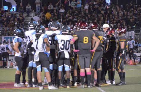 Referees call players from both Colton and Grand Terrace High to midfield to put an end to the excessive aggressive play near the end of the first quarter.