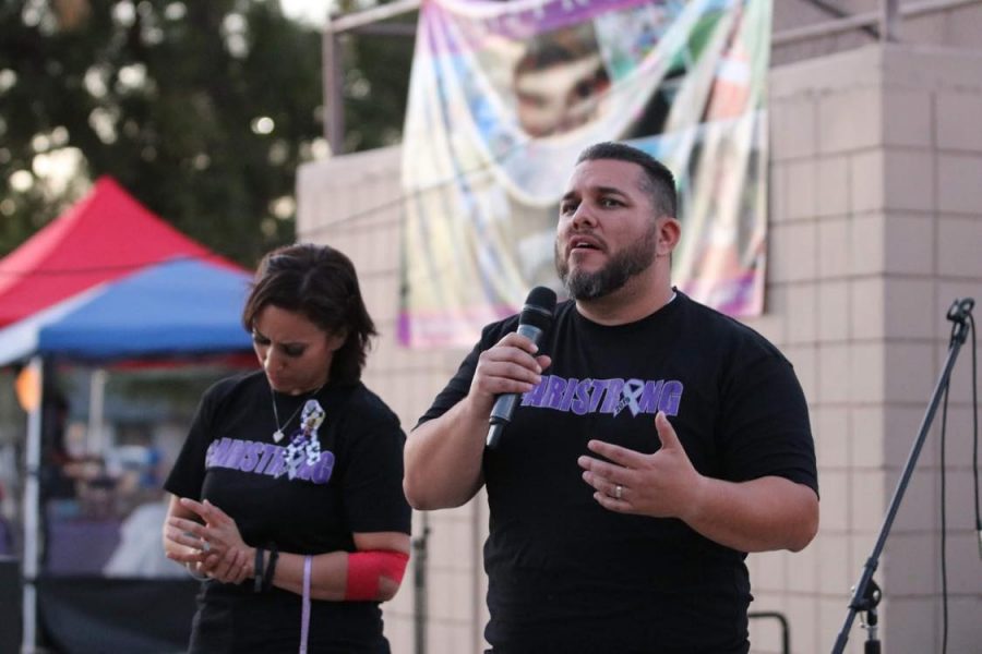 Chris and Nikki Villalobos address a crowd of guests at the 2019 #Aristrong Car Show and Kickball Tournament event in Colton.