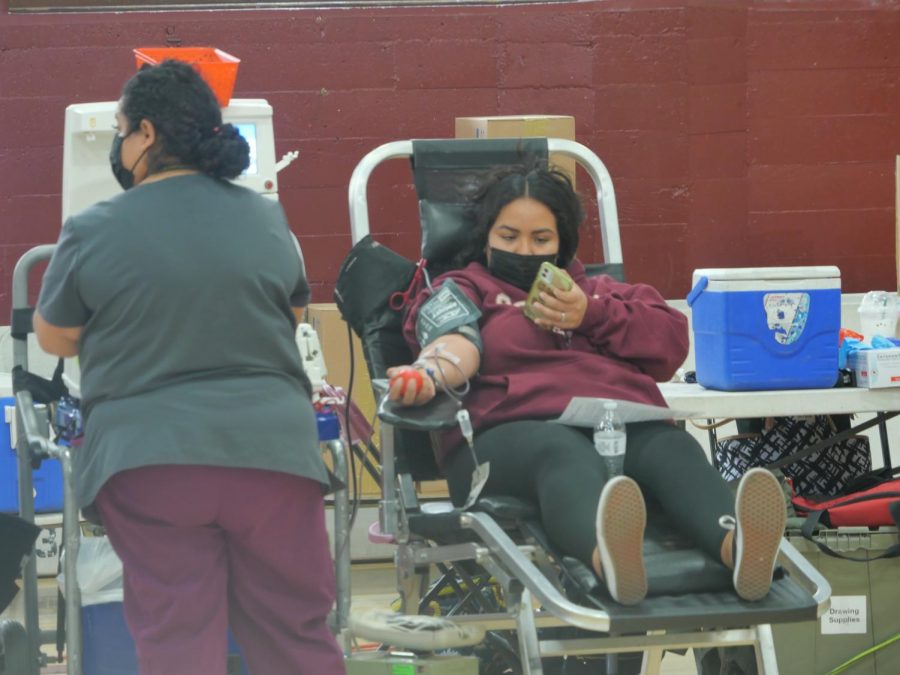 Senior Emily Hernandez checks her phone as her blood is drawn at the second LifeStream Blood Drive of the 2021-22 school year.