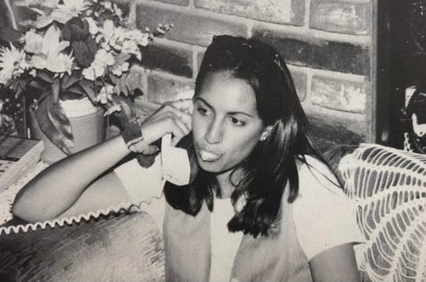 Senior Victoria Molner is caught at home in 1994, blowing bubbles as she talks on the phone.