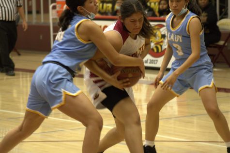Madison Barrera toughs out this drive to the hoop in the first half of the game against BHS, on her way to a team leading 13 points.