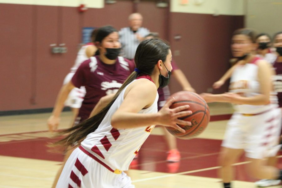Zoey Espino moves along the perimeter, looking for her open teammates.