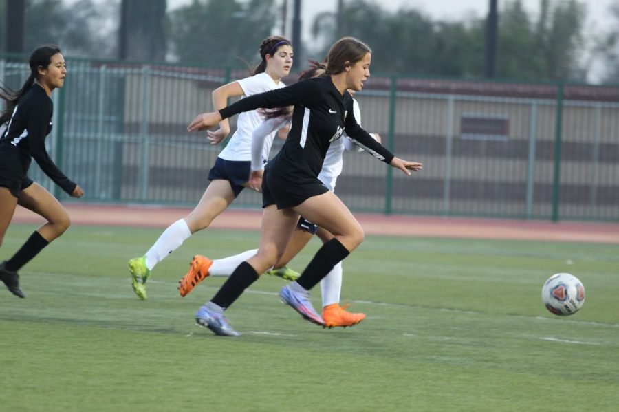 Anna Bailey crosses over the midfield to take a shot on goal.