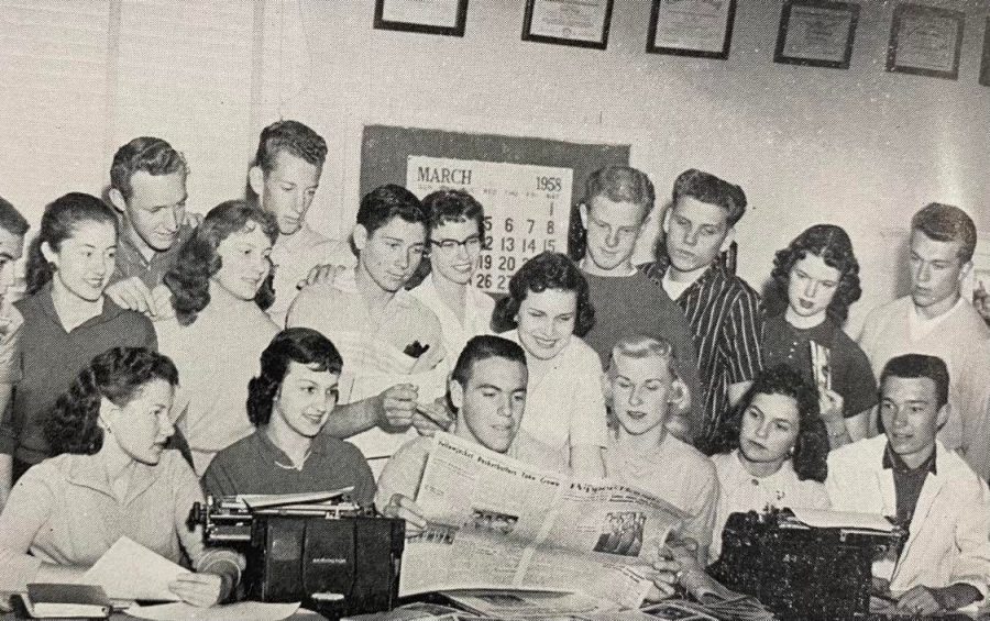 The 1958 Pepper Bough staff looks over the paper.