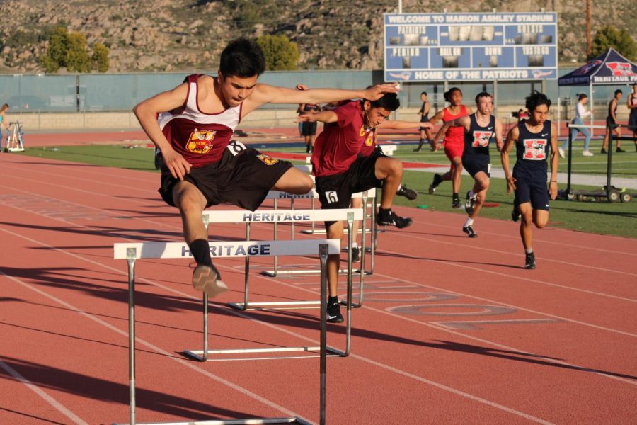 Junior Matthew Fuentes leads the charge in the varsity boys 300 hurdles at the Heritage High meet.