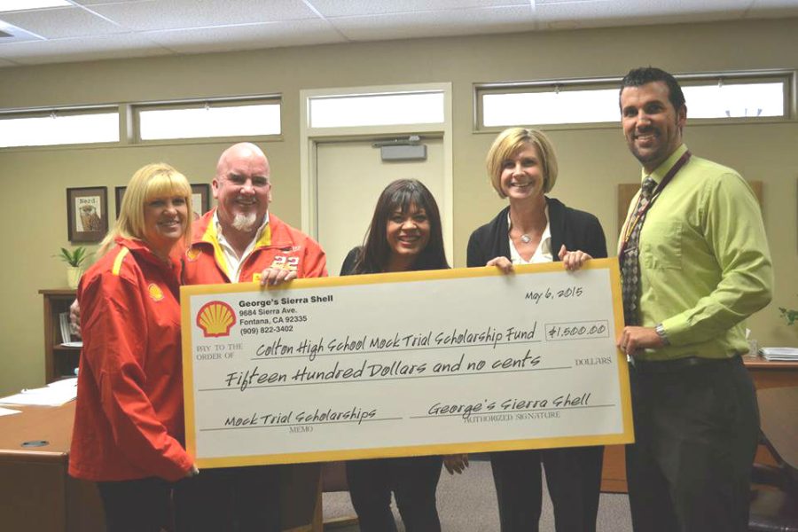 Doug and Linda Whiteman, owners of Georges Shell in Fontana, present a check in the amount of $1,500 to the Colton High Mock Trial Scholarship Fund.  There to receive the reward were adviser Lucy Leyva, principal Joda Murphy, and assistant principal Brian Pope.