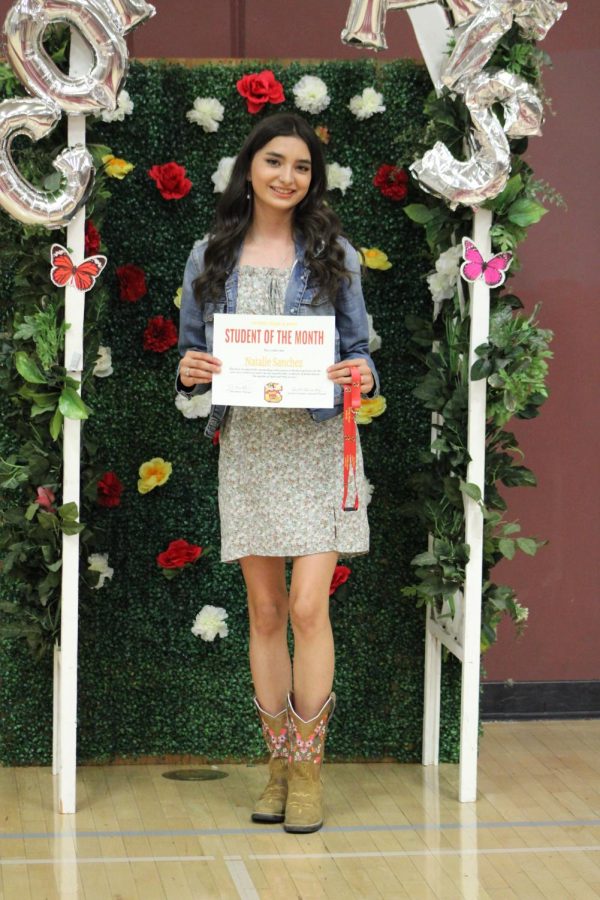 Natalie Sanchez shows off her Student of the Month Award and some sweet boots at the Congrats booth.