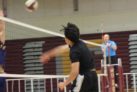 Juan Terriquez rises for the powerful spike during the mens volleyball game against Bloomington High. Yellowjackets dropped this game, 2 sets to 1.