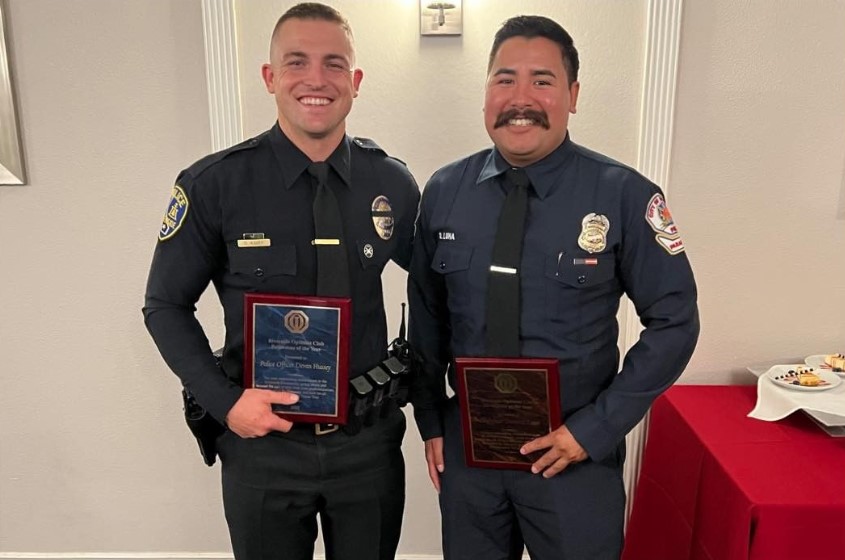 Officer Devan Hussey (left) with his award as Optimist Club Police Officer of the Year. He is joined by firefighter Dominic Luna, who was named Firefighter of the Year.