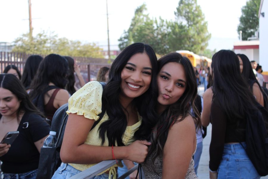 Marissa Lopez and Leiloni Zesati take a moment from their ASB duties to enjoy the start of their senior years over by the Rancho Ave. entrance.