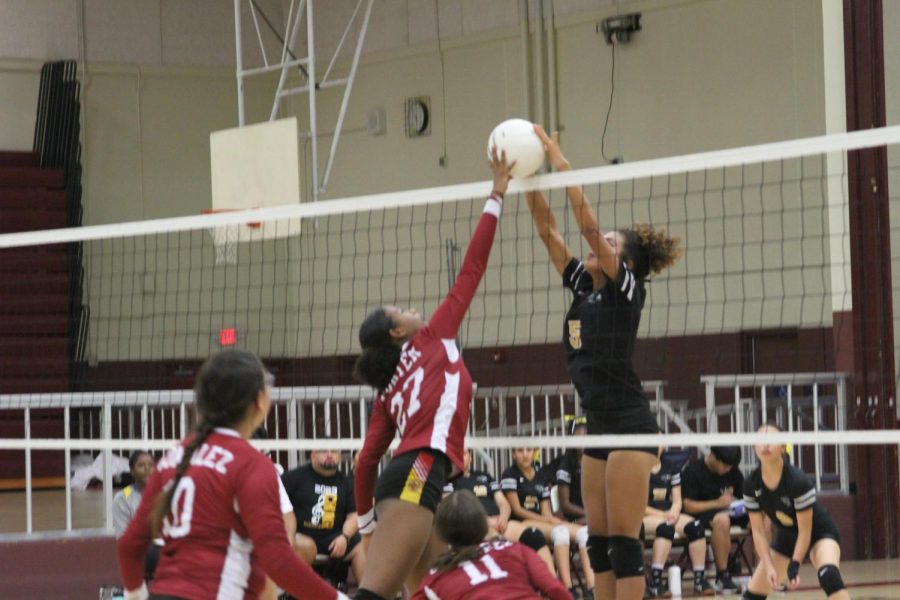Jayda Porter refuses to let Mia Green of Rubidoux have her way at the net, fighting back with a beautiful block.