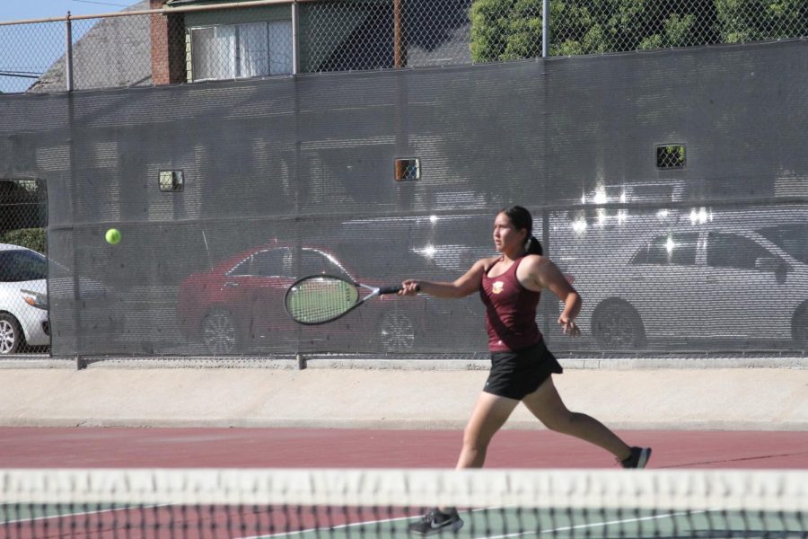 Kimberly Emilio fires off a strong forehand against her opponent from Grand Terrace.