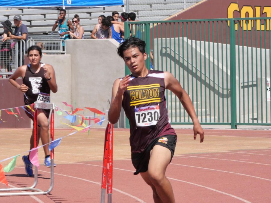 Daniel Montes tears around the final turn on the track at Memorial Stadium to finish the last first race of his senior year strong. He crossed the finish line at 24:07.1.
