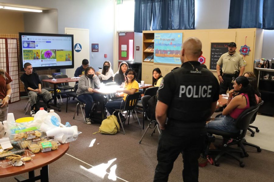 School Resource Officer Anthony Elisarraraz addresses a group of students after school as part of Cookies with a Cop.