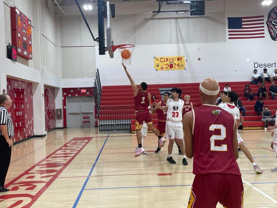 Devin Torrez slices through the lane to score two of his team high 17 points against Desert Mirage.
