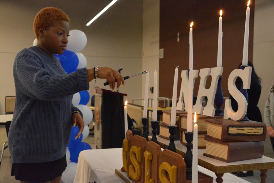 NHS Secretary Mercy Mgbemere lights a candle on as part of the NHS Induction Ceremony on Nov. 15, 2022.