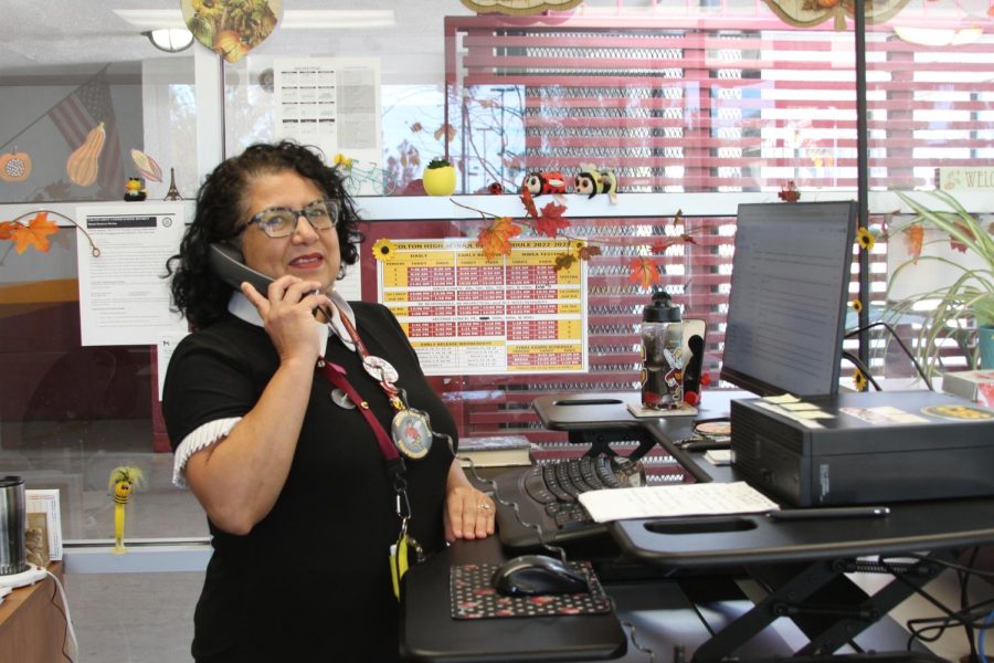 CHS receptionist, Cynthia Garcia takes time between answering phone calls and serving the public to play music for the school every morning.