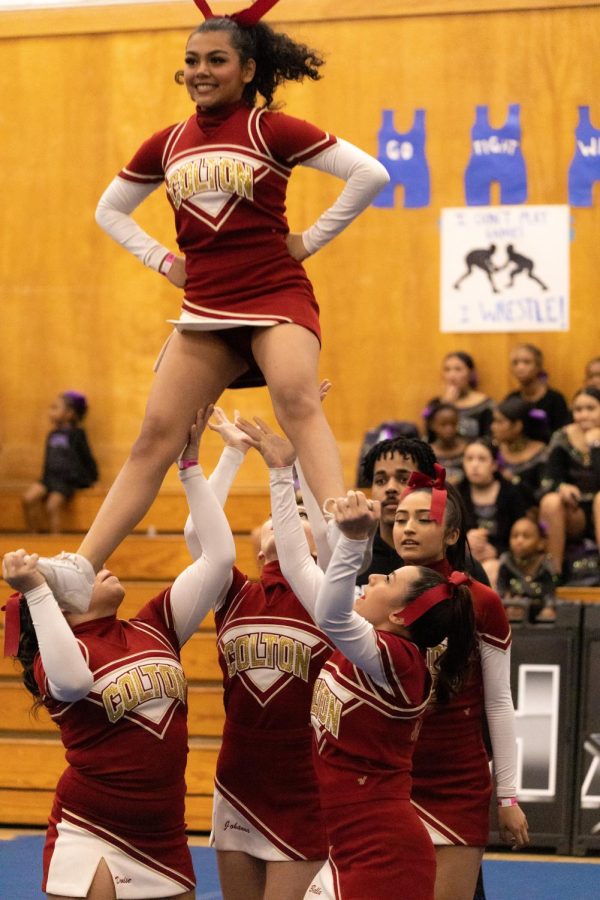 Denise Diaz and Bella Winter set a solid base for flyer Jennifer Ascencio during the groups opening stunt.