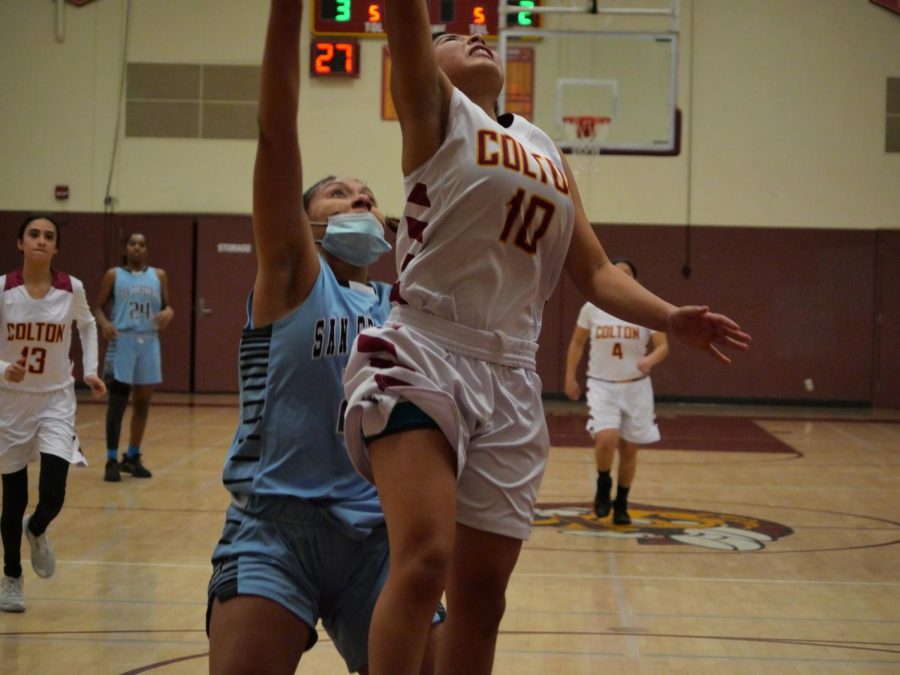 Savannah Govea manages to put up a shot after getting fouled by Jaylen Russell.