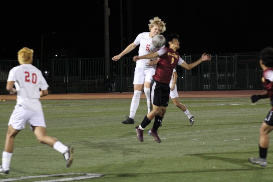Palm Deserts Cash Anderholt throws himself into Yahir Rodriguez in a header play at midfield in the second half.