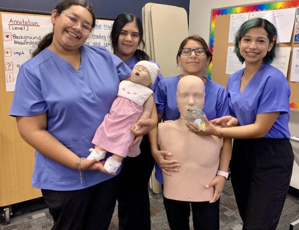 CNA students show off team spirit with a makeshift family photo. 