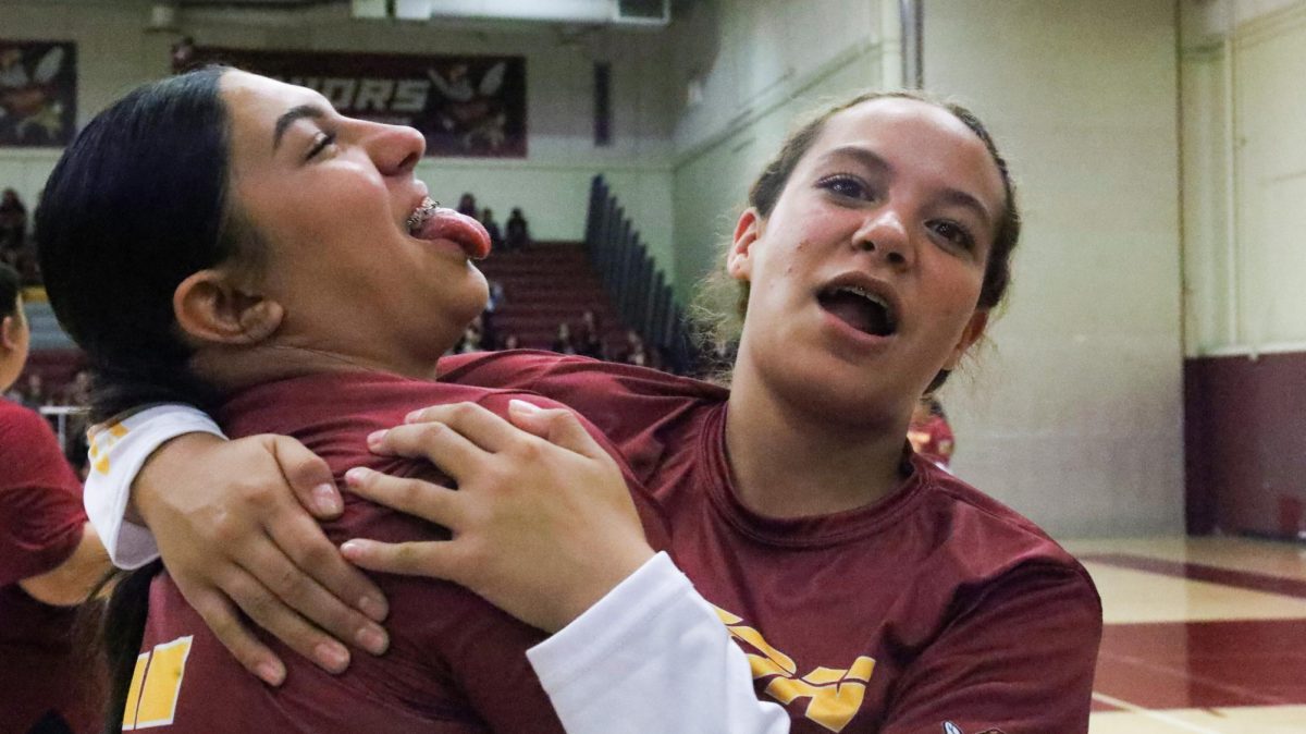 Randi Bailey and Kayesi Romo have some fun on the bench before the game against Canyon Springs on Aug. 24. 