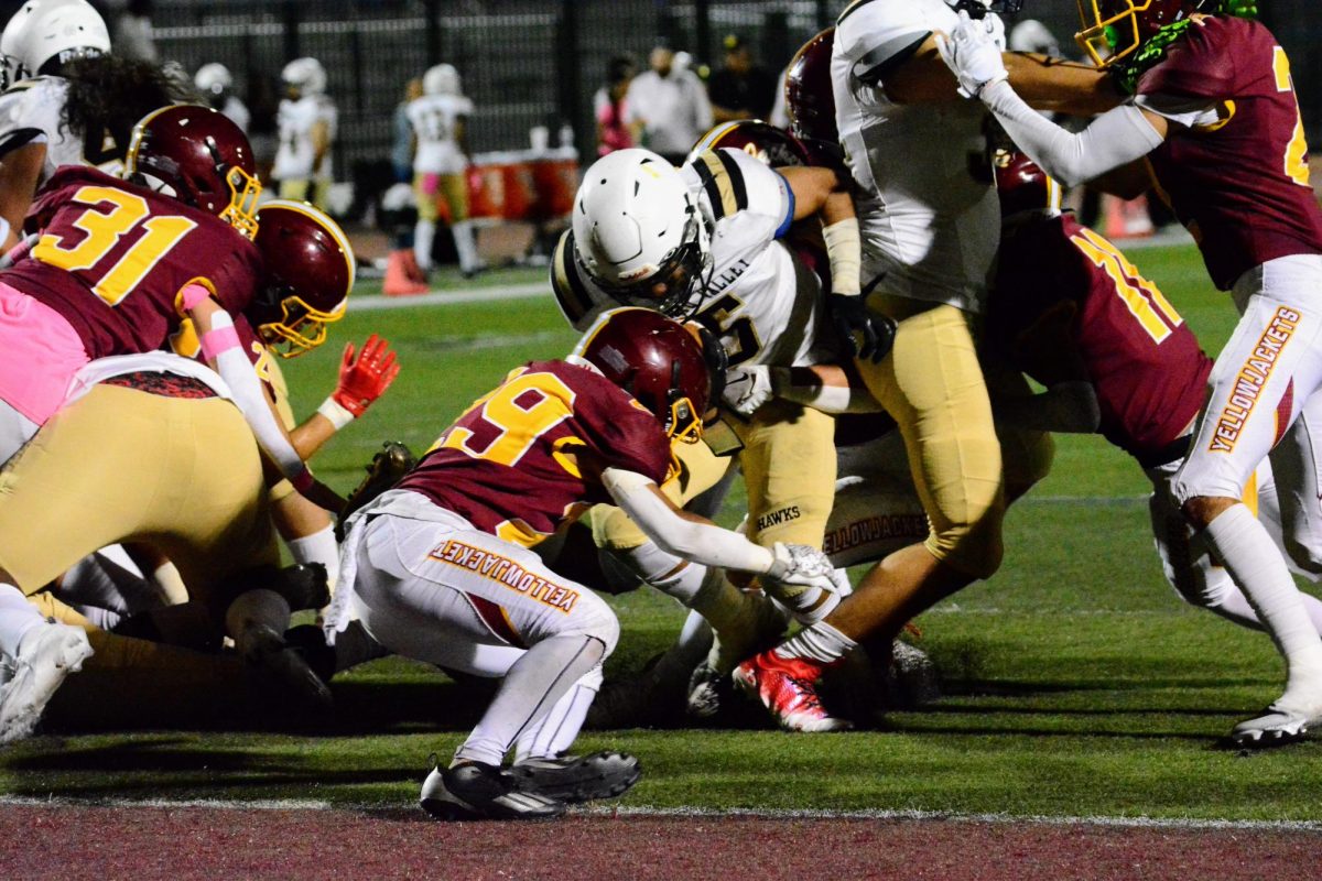 Elias Velasquez and the Colton defense work to stop a touchdown run by the Arroyo Valley Hawks at Homecoming.