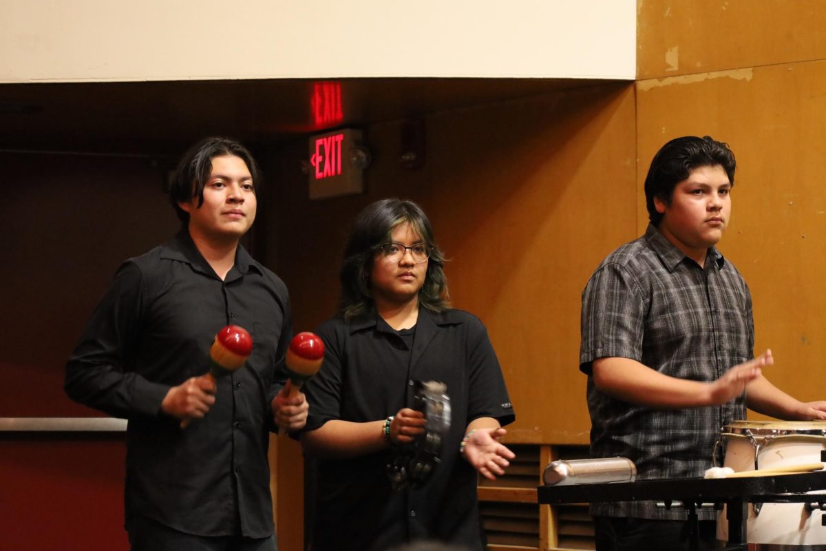 From left to right: Justin Mendez, Cody Ignacio, and Albert Aparicio join in on a percussion feature during the choirs performance of Oye. 