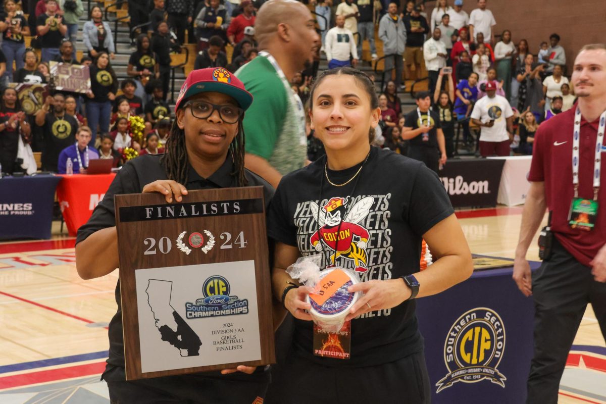 Coaches Keisha Young and Candice Tapia accept the runners-up plaque and CIF Finalists patches on behalf of the girls basketball team for their historically successful season.