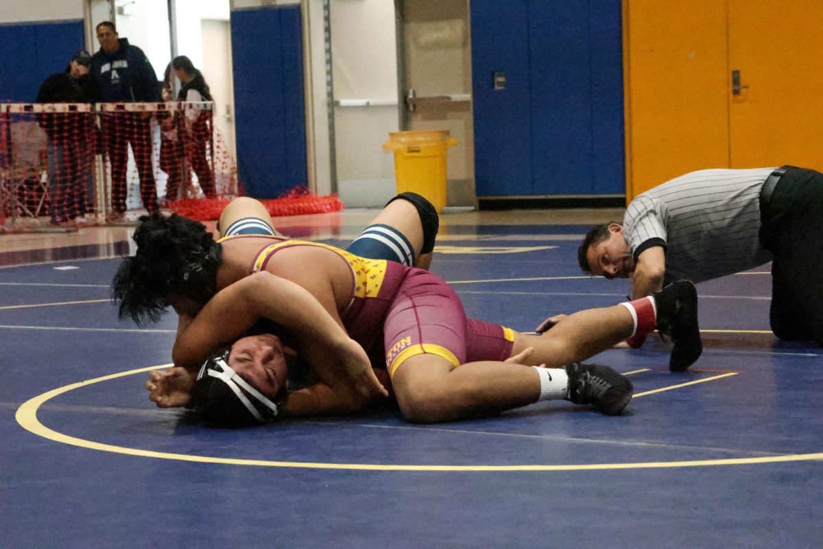 Santino Zamora pins his opponent in less than 30 seconds during the first period of their first match at the League Finals.