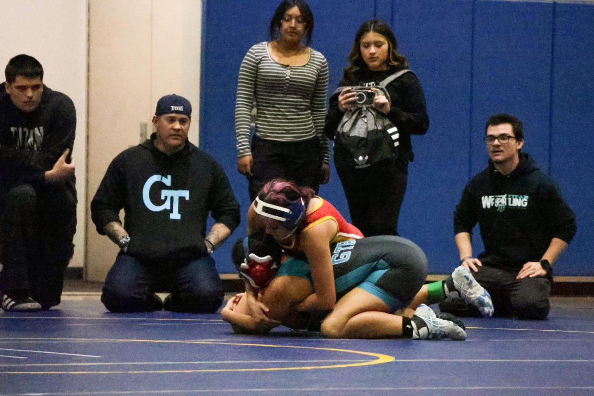 Cambria Duron shows no mercy to her opponent from Grand Terrace as GTs coaches watch on.