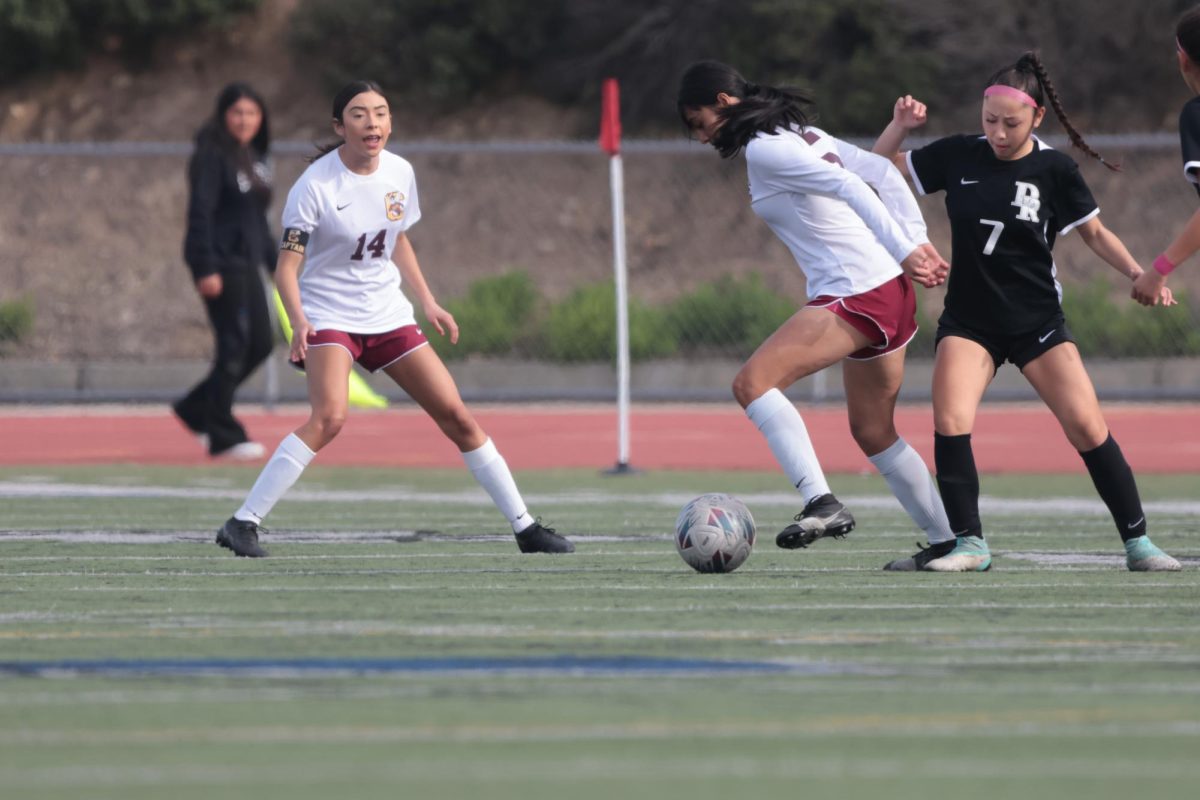 Marina Elkins calls out support to Jade Movassaghi as she dribbles past the Panther defenders midfield.