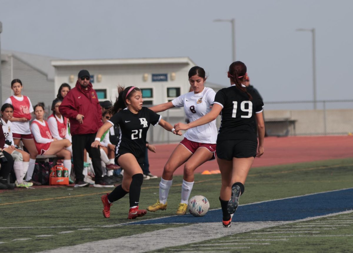 Tiffany Abril finds herself sandwiched between two Panther defenders.