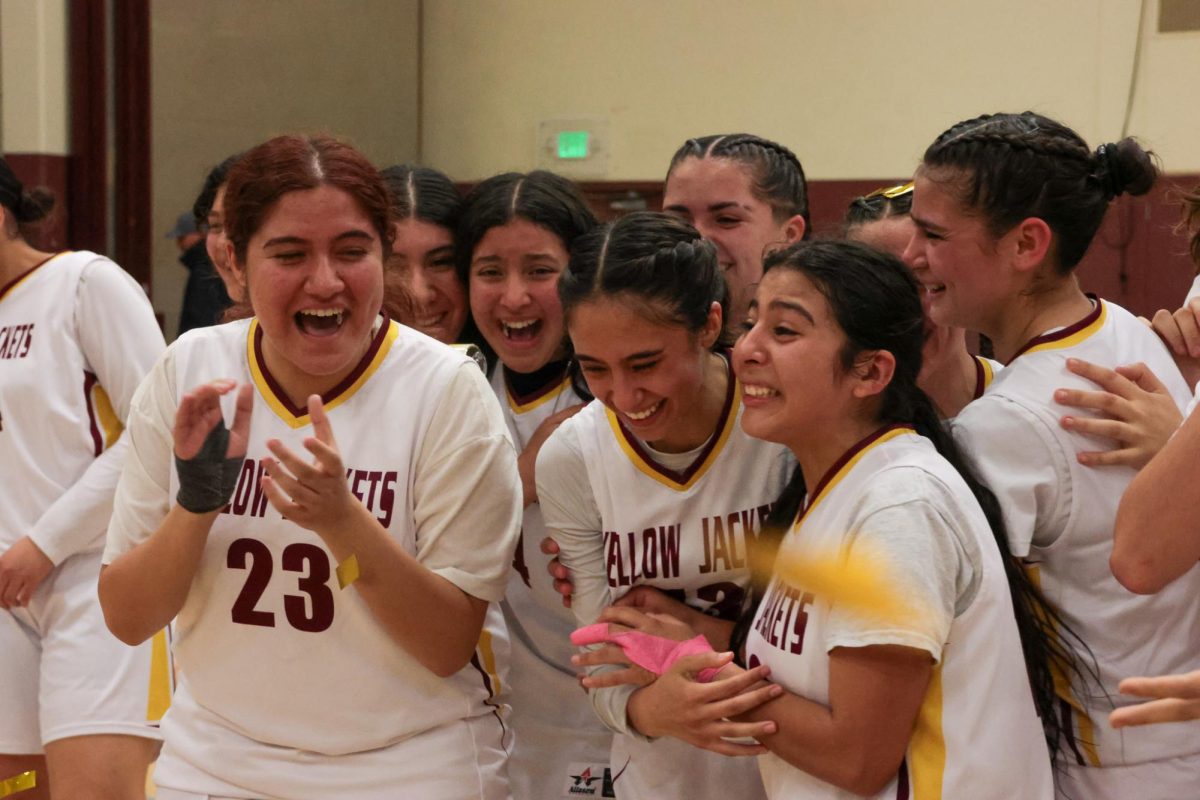 The 2023-24 girls basketball team is overjoyed by their victory as the confetti falls around them. From left: Lia Vellanoweth, Amber Lopez, Gabriella Gomez, Madison Prieto, Izabella Oliver, Savannah Govea, Zoey Espino, Olivia Torres
