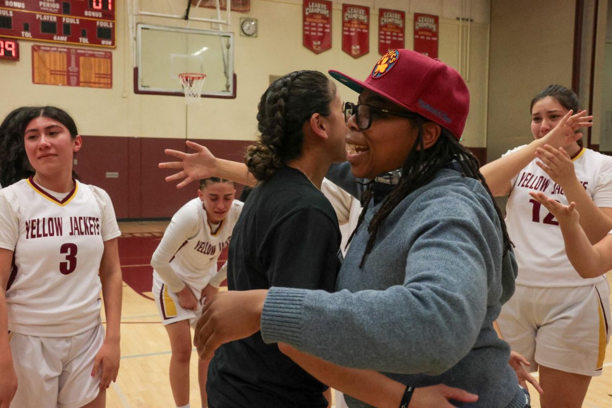 Coaches Keisha Young and Candice Tapia embrace as they celebrate their league title eight years in the making.