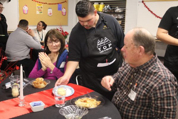TOPS student Fernando Cortez serves lunch to customers at the TOPS Bistro and Cafe on Feb. 15.