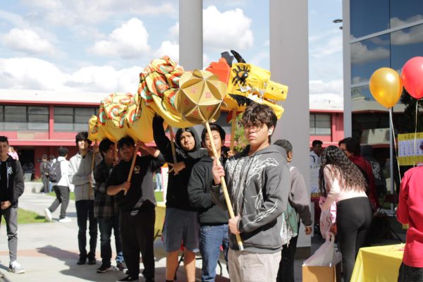 The Dragon Dance crew takes a quick break to show off their impressive puppet.