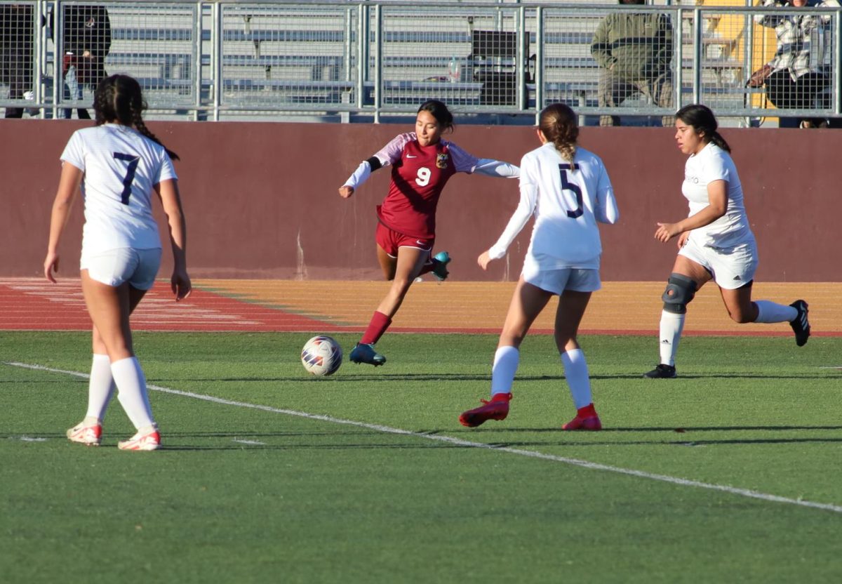 Melanie Bravo races to the ball first.