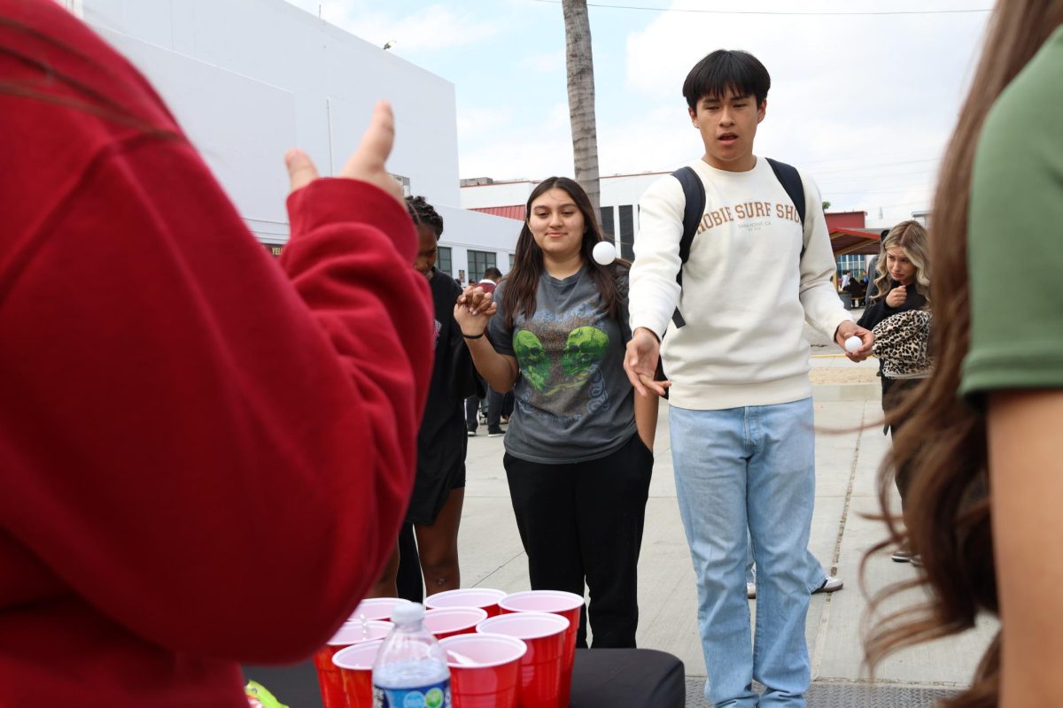 Raymond Mendoza shows off his skills by winning a prize playing cup pong.
