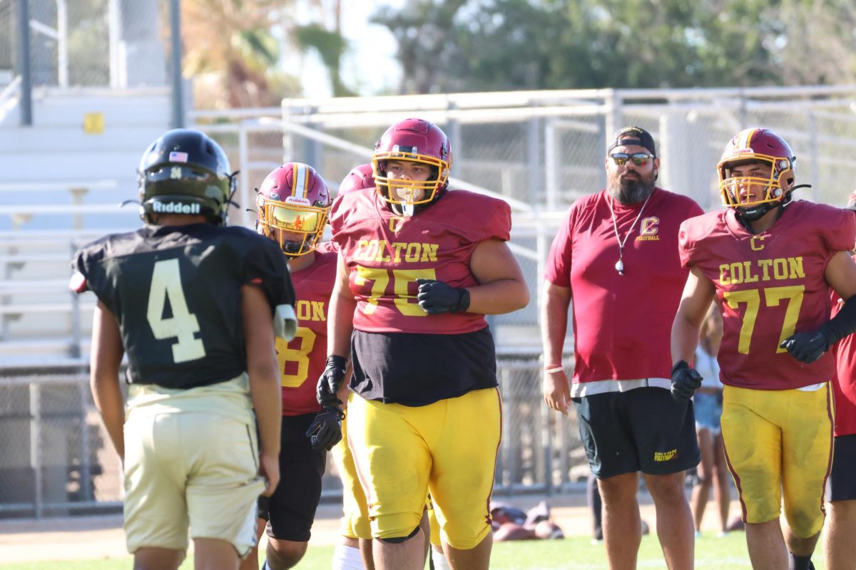 The Yellowjacket offensive line looks ready to mix it up with their opposition. From left: Mateo Barboza, Marcus Rios, Coach Ray Rodriguez and Isaiah Ruiz.