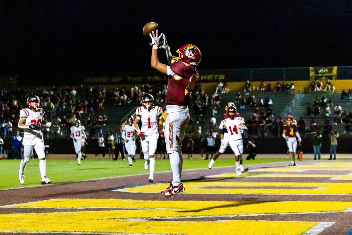 Freshman Jonathan Quiroz leaps to bring down the first touchdown of his high school career early in the game against Arrowhead Christian. Yellowjackets win 23-21.