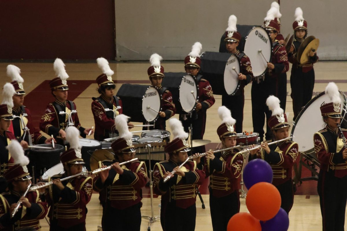 The brass and percussion students carry out their performance in the Hubbs Gym.