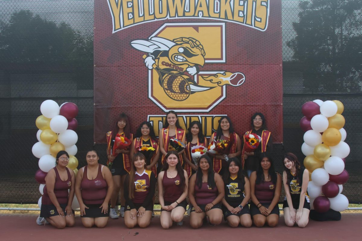 The Varsity GIrls Tennis team poses together for a photo at the Senior Night game.